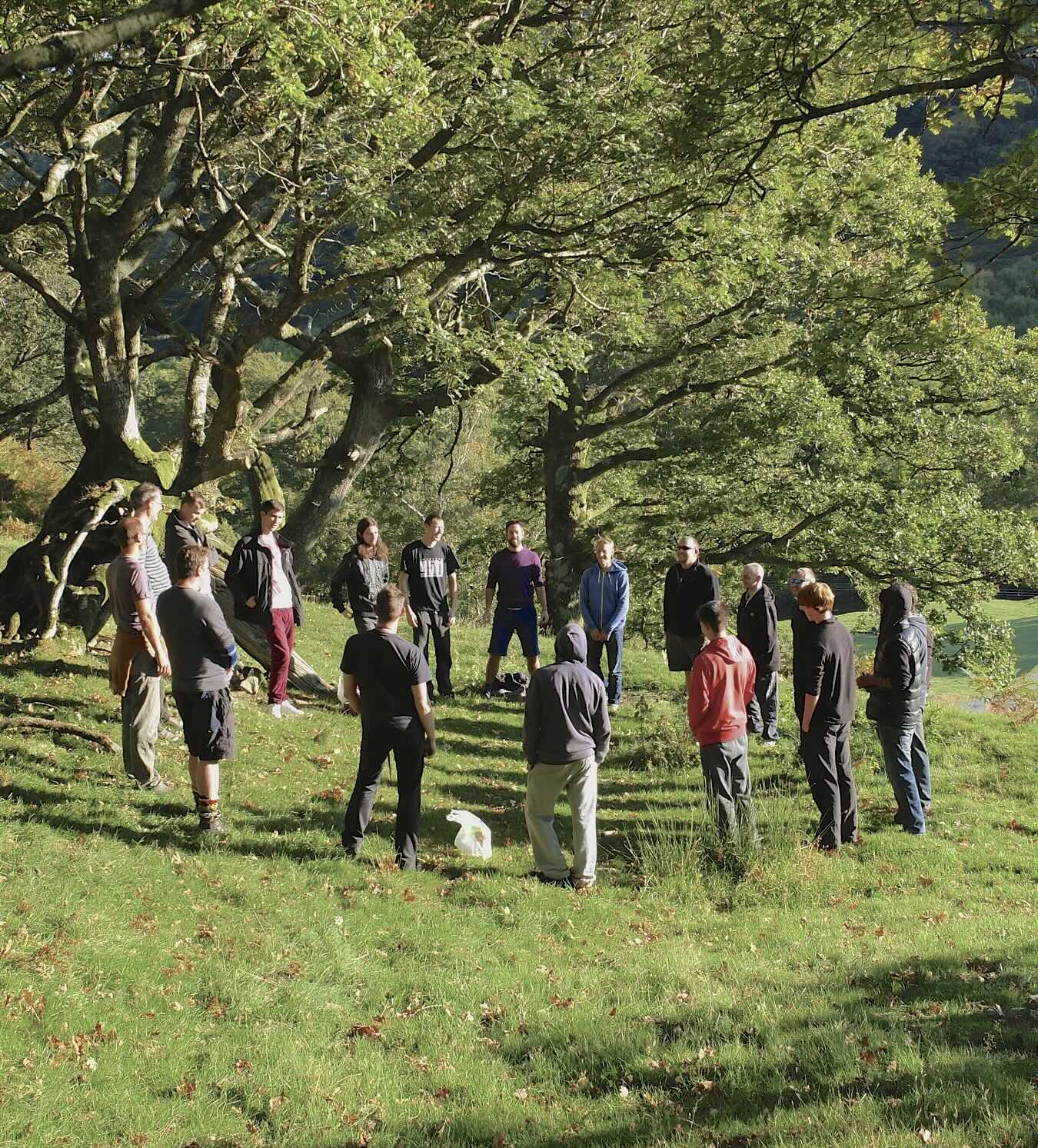 Men in circle outdoors